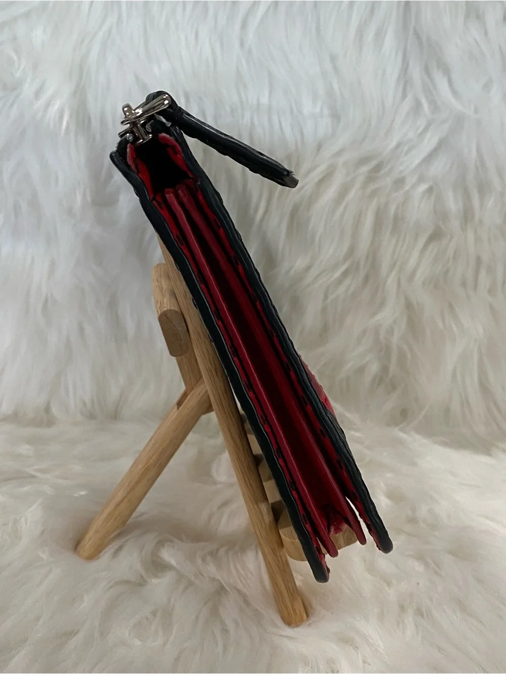 Fendi Selleria flat clutch bag with red stitching and red leather handle